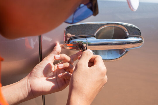 man repairing car lock