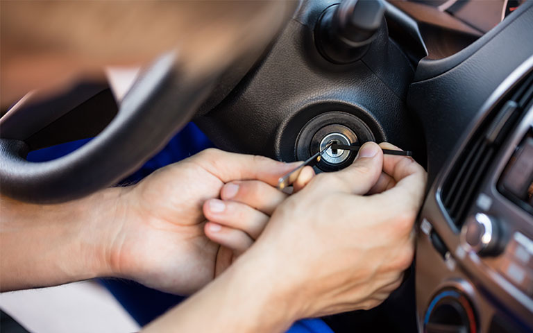 man repairing car lock